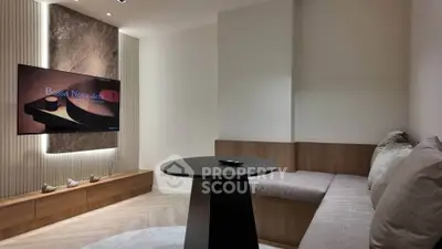 Modern living room with cozy seating and stylish TV setup