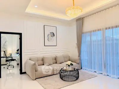 Luxurious living room with elegant chandelier and plush sofa, featuring modern decor and large windows.