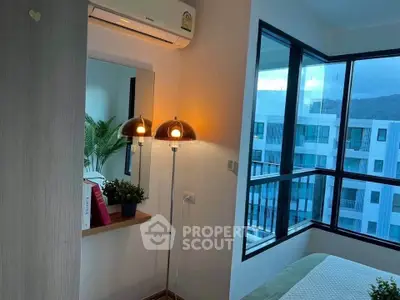 Cozy bedroom with modern decor and large windows offering a stunning view.