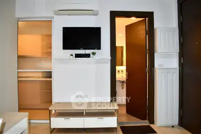 Modern apartment interior with wall-mounted TV and bathroom entrance