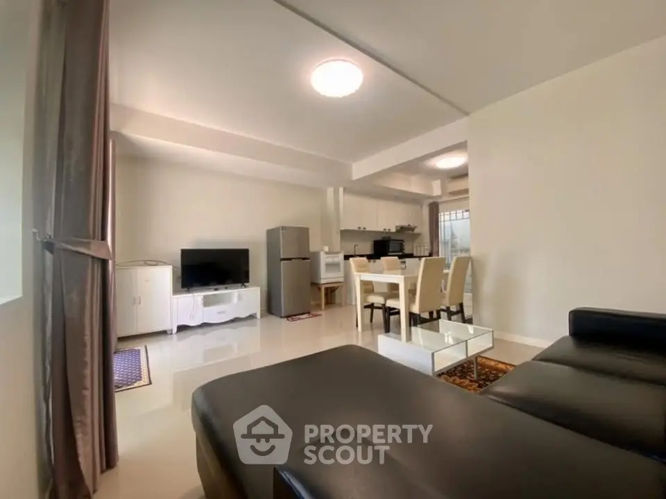 Spacious open-plan living room with modern kitchen and dining area