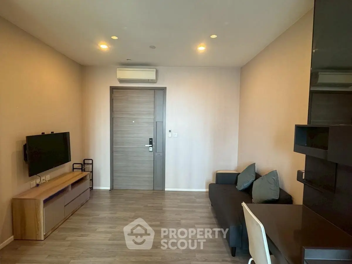 Modern living room with sleek furniture and wall-mounted TV