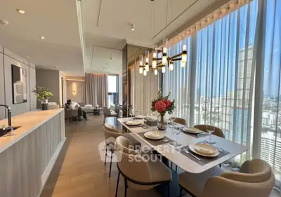 Luxurious open-plan living and dining area with stunning city views and elegant decor.