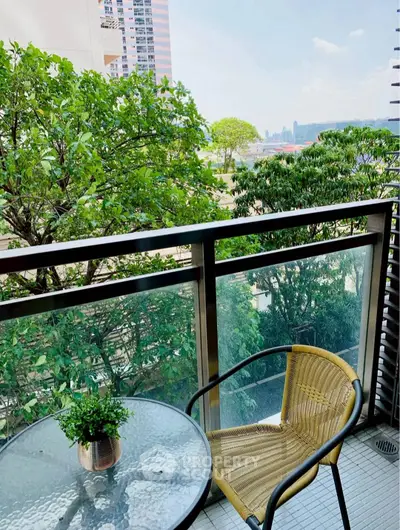 Charming balcony with lush greenery and city view, perfect for relaxation and enjoying nature.