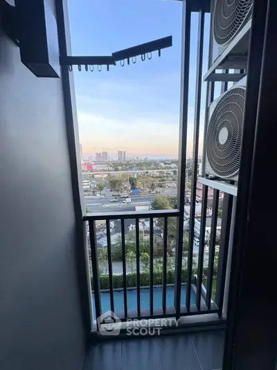 Urban balcony with city view and air conditioning units, perfect for modern living.