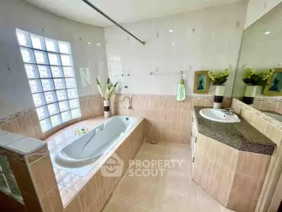 Spacious bathroom with elegant bathtub and modern fixtures