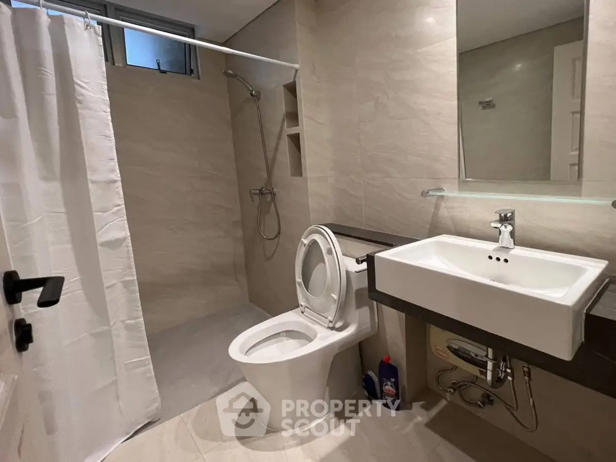 Modern bathroom with sleek fixtures and walk-in shower in a contemporary home.