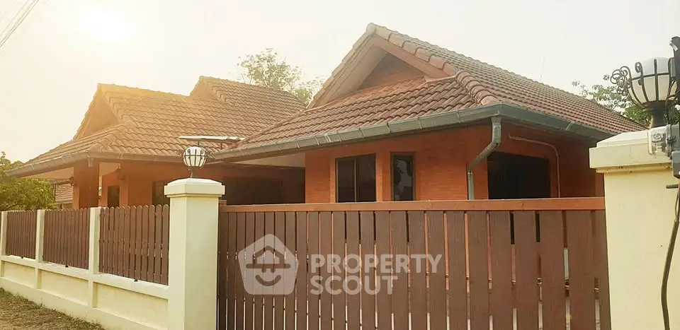 Charming suburban house with red brick exterior and tiled roof, perfect for family living.