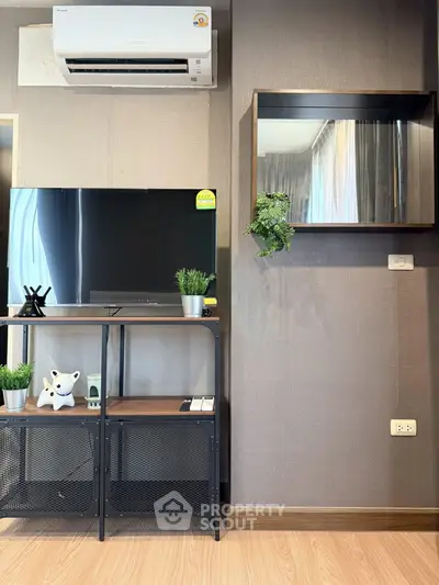 Modern living room with sleek TV stand, air conditioning, and stylish decor