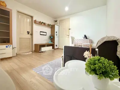 Cozy living room with modern decor and wooden flooring, perfect for relaxation and entertainment.