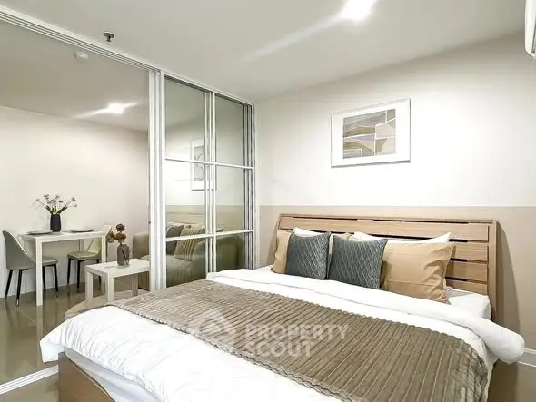 Modern bedroom with stylish decor and cozy ambiance, featuring a comfortable bed and elegant furnishings.