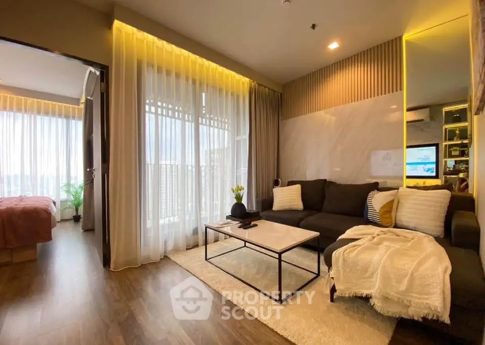 Modern living room with cozy decor and natural light, featuring a stylish sofa and elegant curtains.