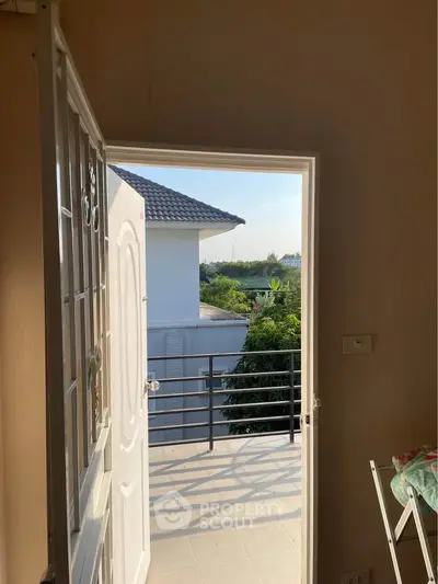Charming balcony view with lush greenery and modern architecture, perfect for relaxing and enjoying the outdoors.