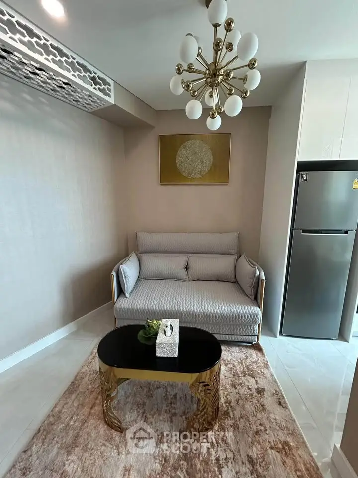 Stylish living room with modern chandelier and cozy sofa in elegant apartment.