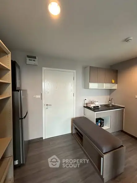 Modern compact kitchen with sleek cabinetry and stainless steel appliances