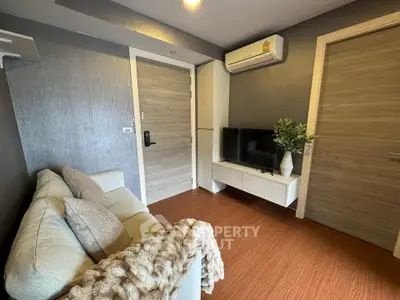 Cozy living room with modern decor and air conditioning in a stylish apartment.