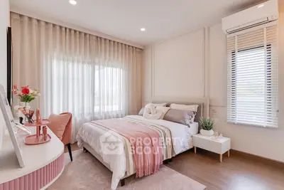 Elegant bedroom with stylish decor and natural light, featuring cozy bed and modern furnishings.