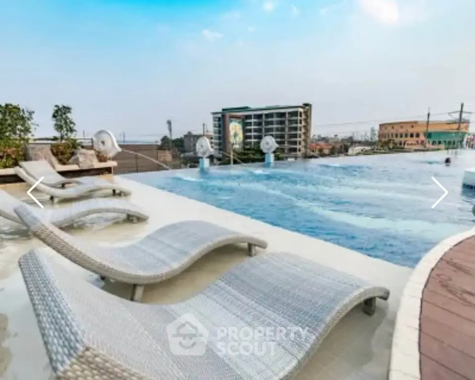 Luxurious rooftop infinity pool with stunning city views and modern lounge chairs.