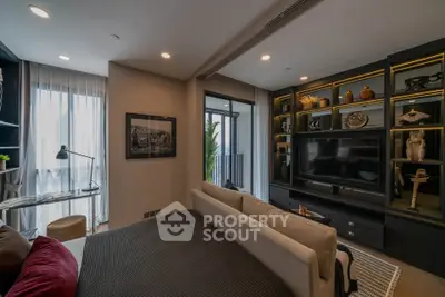 Luxurious modern living room with elegant decor and large TV unit, featuring a cozy sofa and stylish shelving.