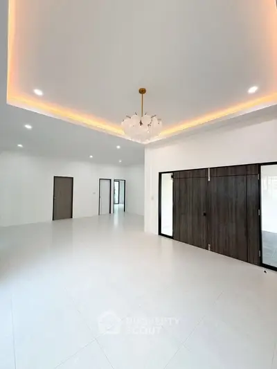 Spacious modern living room with elegant lighting and sliding doors
