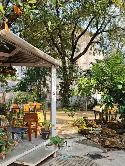 Charming garden area with lush greenery and outdoor seating, perfect for relaxation and gatherings.