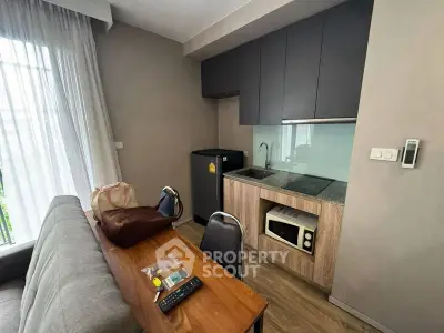 Modern compact kitchen with sleek cabinetry and integrated appliances in cozy apartment.