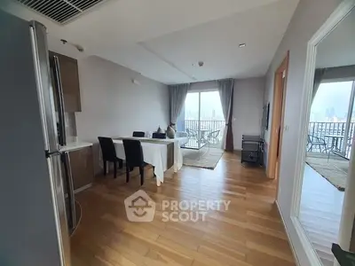 Spacious living room with dining area and balcony view in modern apartment.