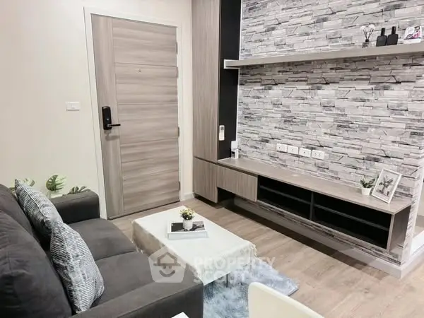 Modern living room with stylish stone accent wall and cozy seating area.