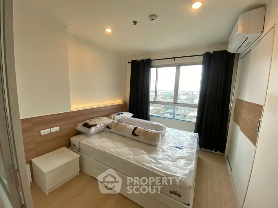 Cozy bedroom with large window and modern furnishings