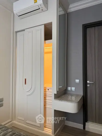 Modern bedroom with built-in closet and air conditioning unit