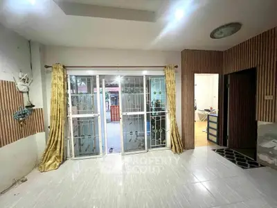 Spacious living room with sliding glass doors and elegant curtains