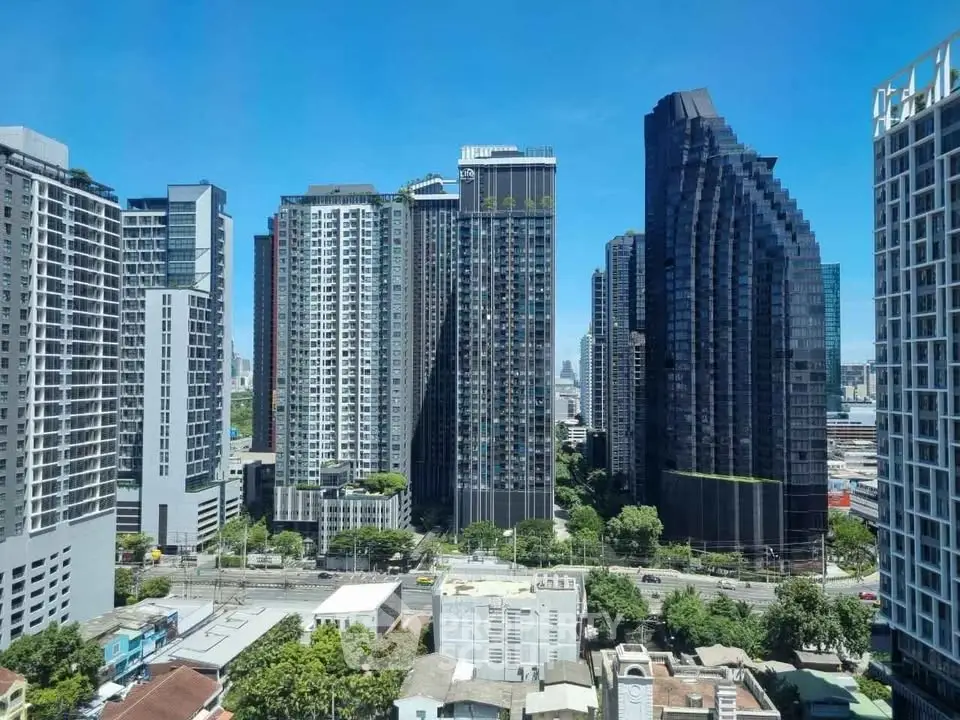 Stunning cityscape view of modern high-rise buildings under a clear blue sky, showcasing urban living at its finest.