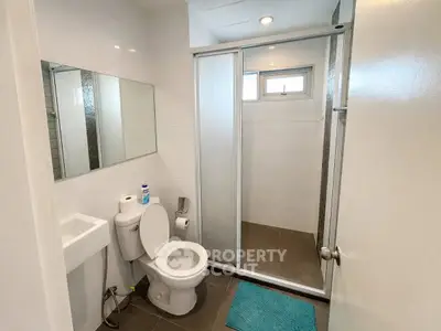 Modern bathroom with shower and sleek fixtures in a contemporary home.