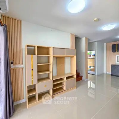 Modern living room with sleek built-in shelving and glossy tile flooring
