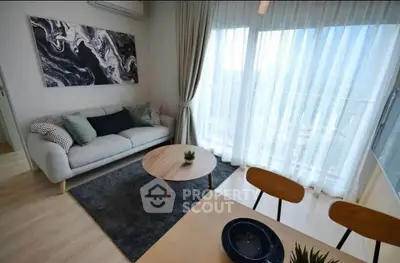 Modern living room with stylish decor and large window for natural light