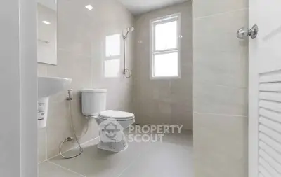 Spacious modern bathroom with elegant fixtures and natural light.