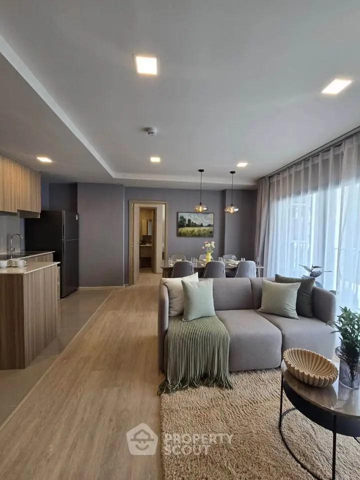 Modern open-plan living room with stylish decor and natural light