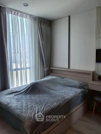 Cozy bedroom with modern design and large window for natural light