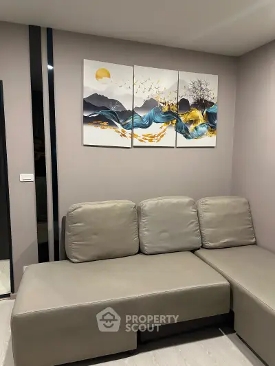 Modern living room with stylish sectional sofa and artistic wall decor