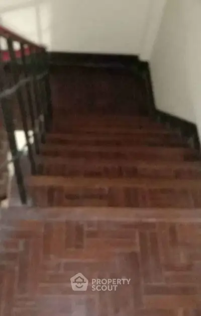 Dimly lit wooden staircase in residential building