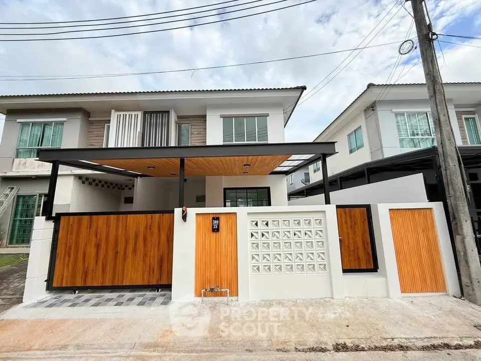 Modern two-story house with stylish wooden gate and contemporary design in a suburban neighborhood.