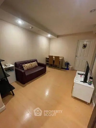 Cozy living room with modern furniture and warm lighting, perfect for relaxation and entertainment.