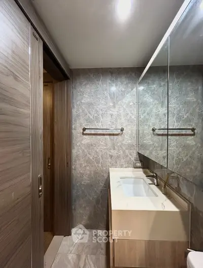Modern bathroom with marble walls and sleek vanity