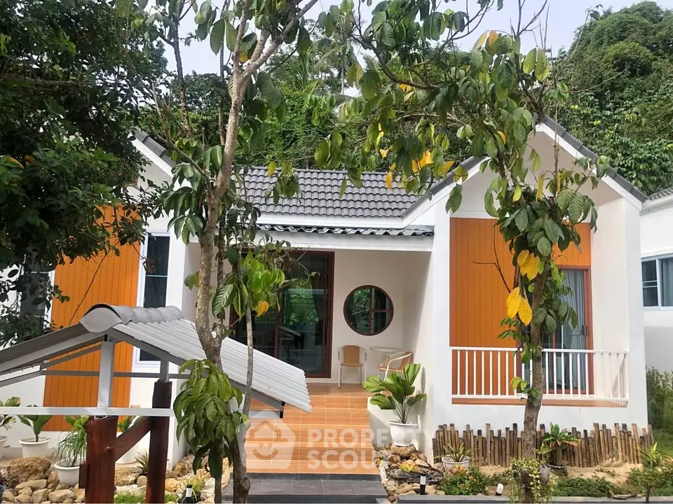 Charming modern house with lush garden and inviting entrance, perfect for serene living.