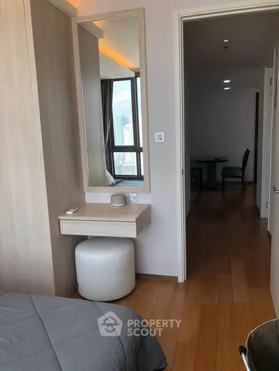 Modern bedroom with wooden flooring and stylish vanity area