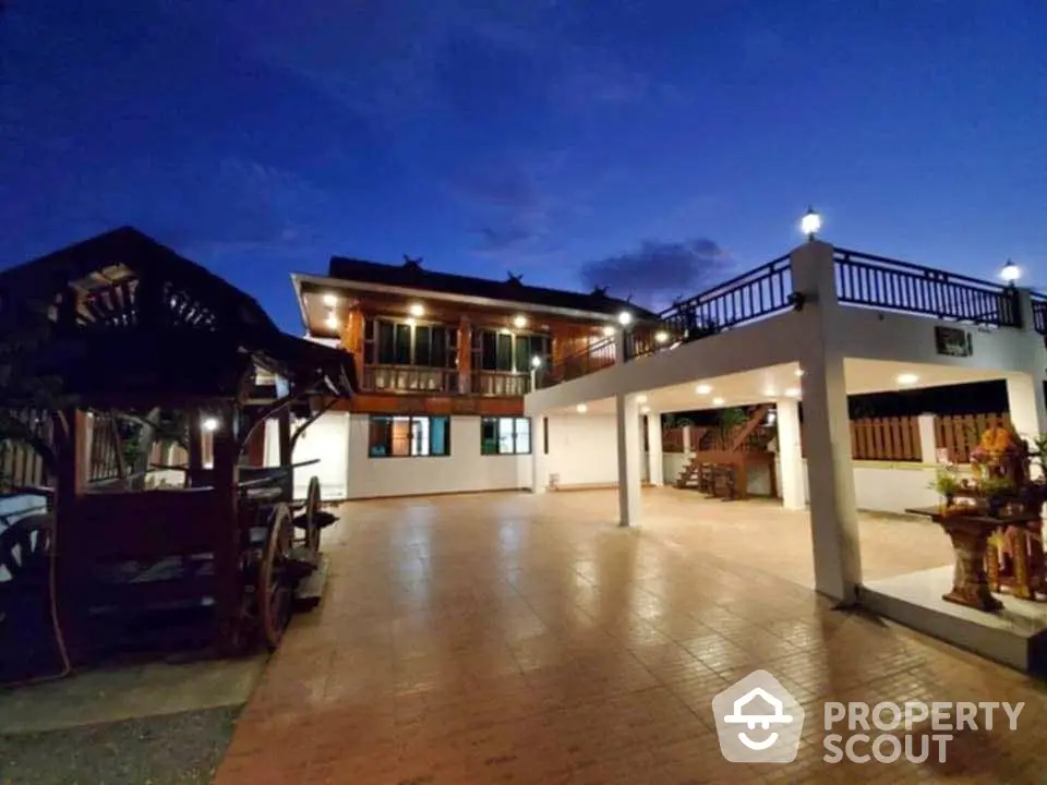 Stunning two-story home with spacious outdoor area and traditional architecture at dusk.