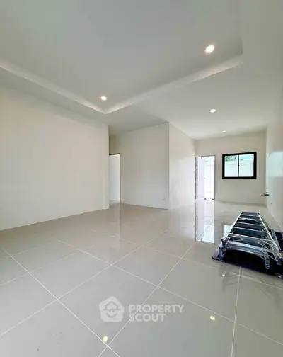 Spacious modern living room with glossy tiled floors and recessed lighting.