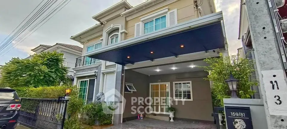 Elegant two-story house with modern facade and spacious driveway in a serene neighborhood.