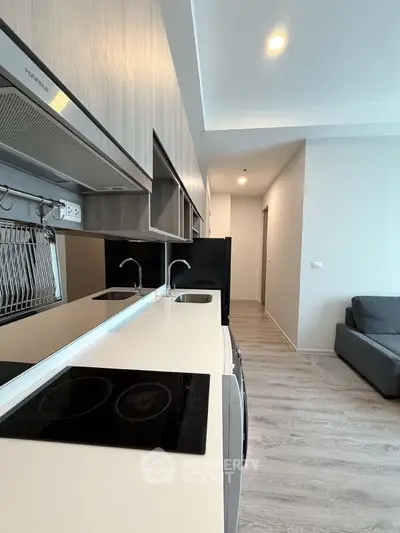 Modern kitchen with sleek countertops and integrated appliances in a stylish apartment.
