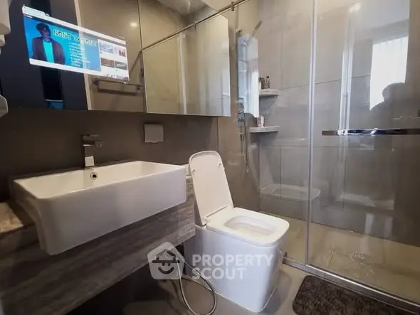 Modern bathroom with sleek fixtures and glass shower enclosure